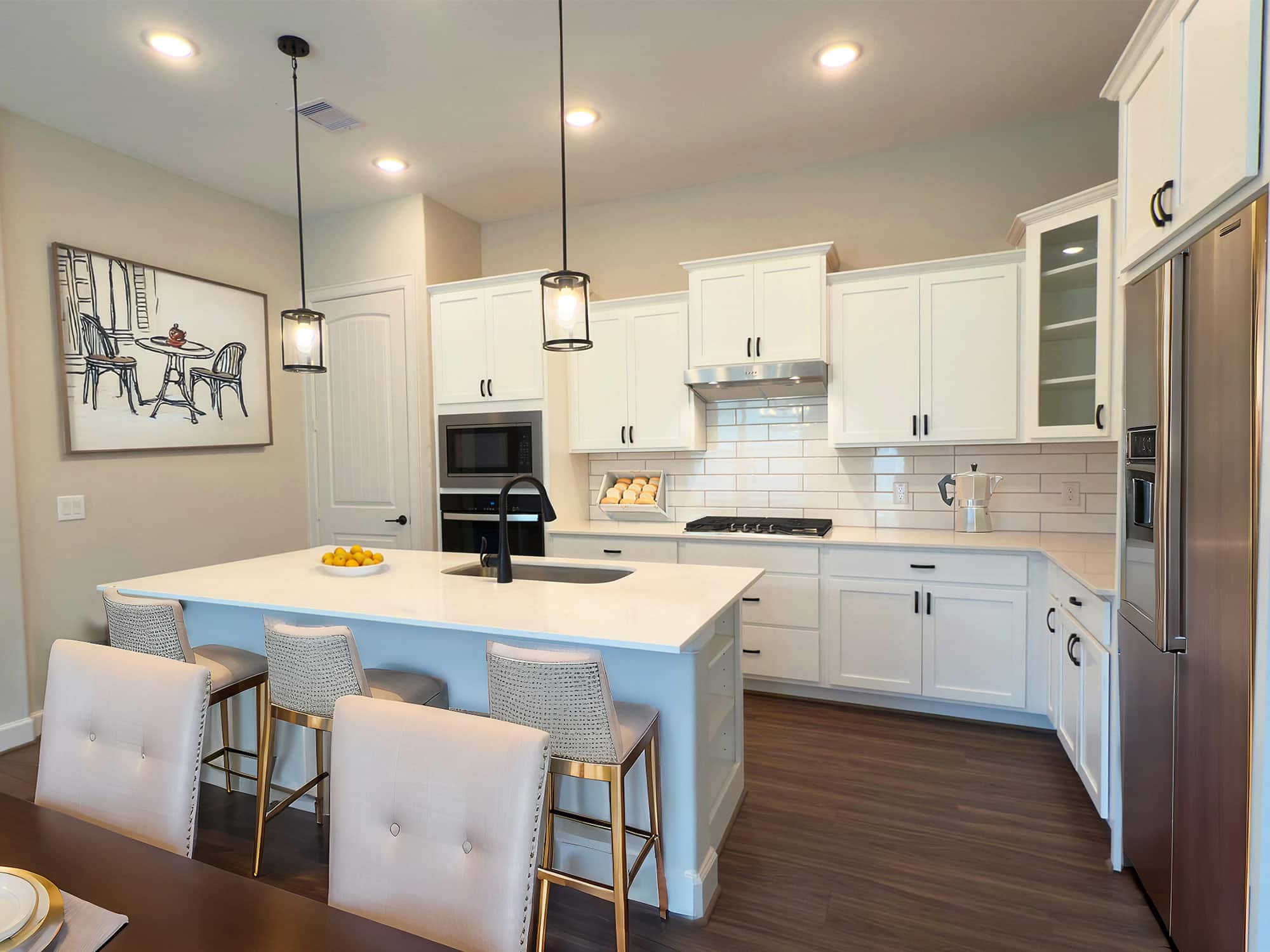 Palazzo kitchen with white cabinets, pendant lights, and center island at 1206 Hidden Oaks Dr