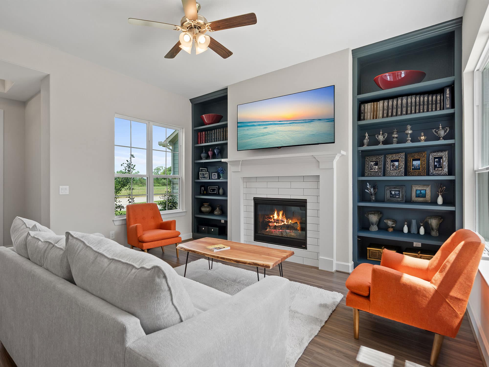 Palazzo living room with fireplace and built-in shelving at 1206 Hidden Oaks Dr