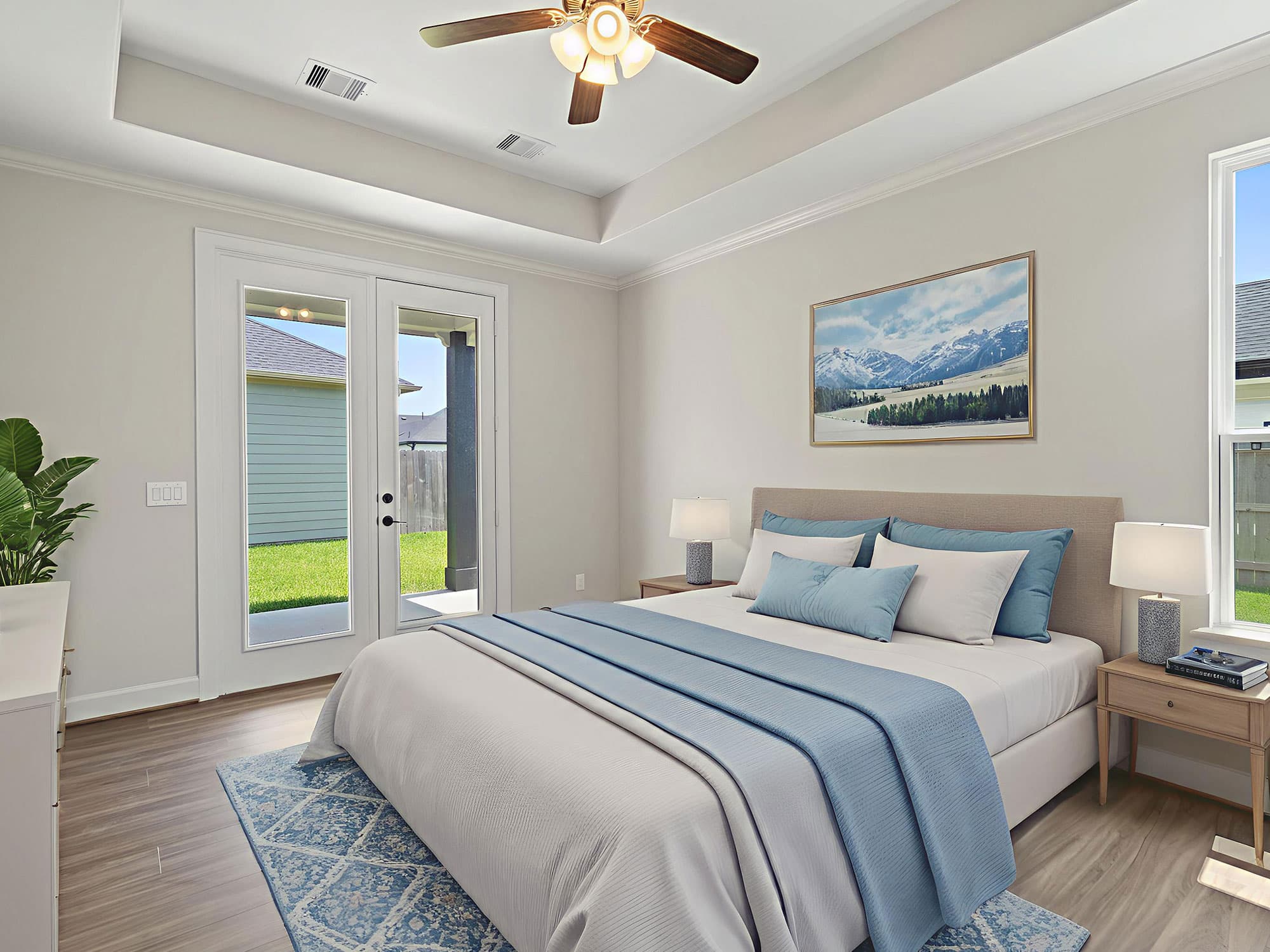Palazzo primary bedroom with tray ceiling and French doors at 1206 Hidden Oaks Dr