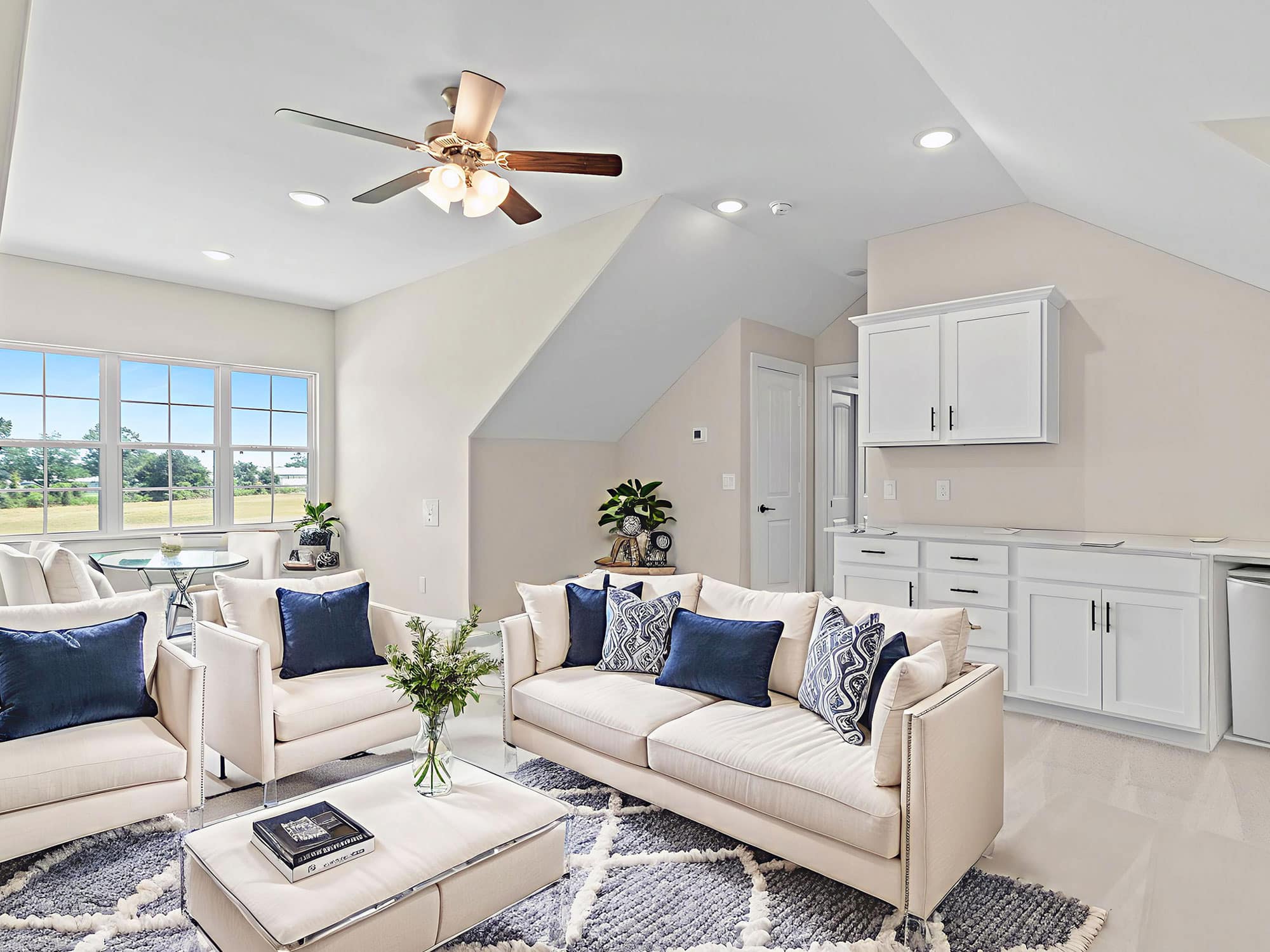 Portico second-floor bonus suite with sitting area and kitchenette at 1306 Hidden Oaks Dr