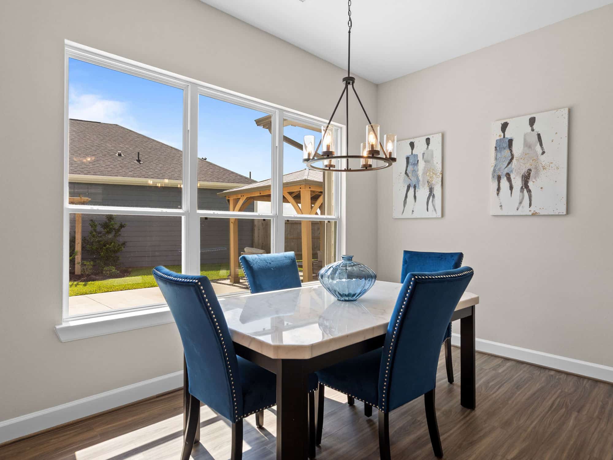Portico dining area with chandelier and large windows at 1306 Hidden Oaks Dr