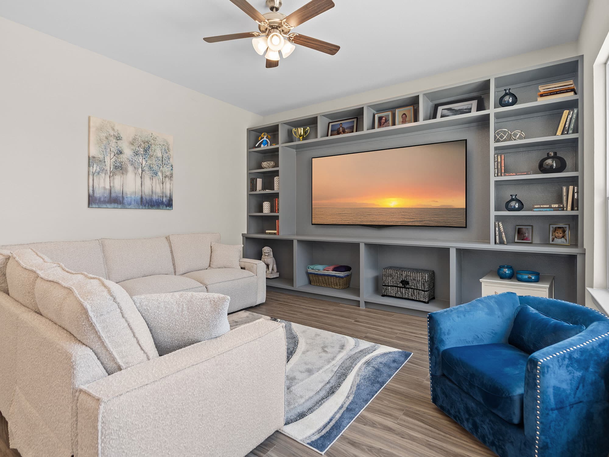 Portico living room with built-in media wall at 1306 Hidden Oaks Dr