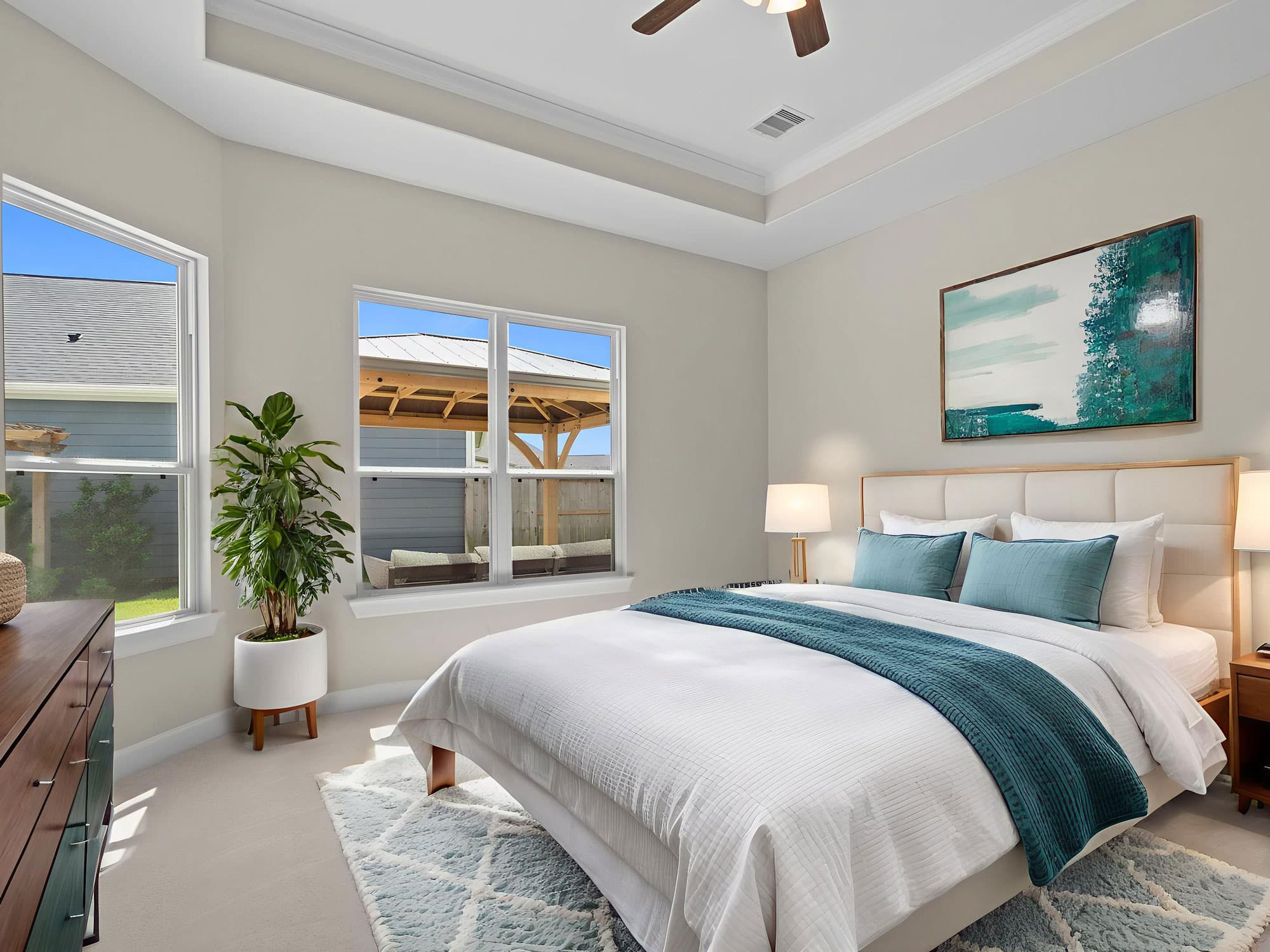 Portico primary bedroom with tray ceiling and ceiling fan at 1306 Hidden Oaks Dr